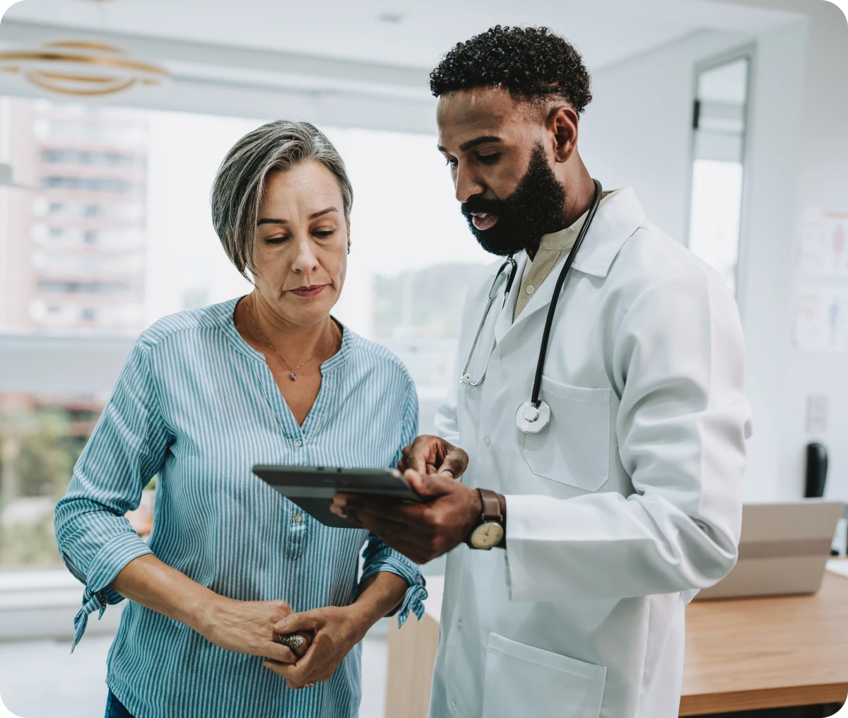 Doctor consulting patient using a tablet